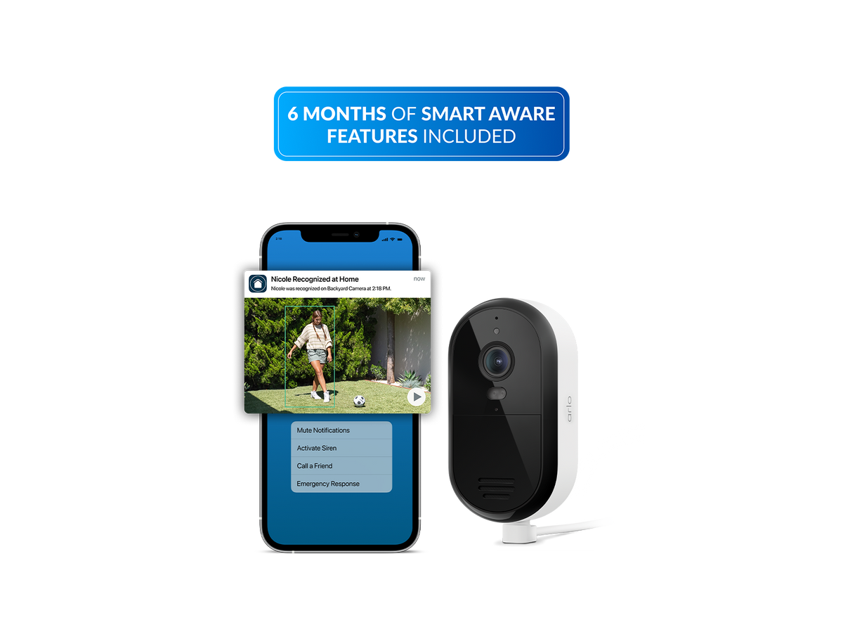 A Essential plug in security camera shown beside a smartphone app screen on a white background, with a blue banner at the top reading '6 MONTHS OF SMART AWARE FEATURES INCLUDED'.