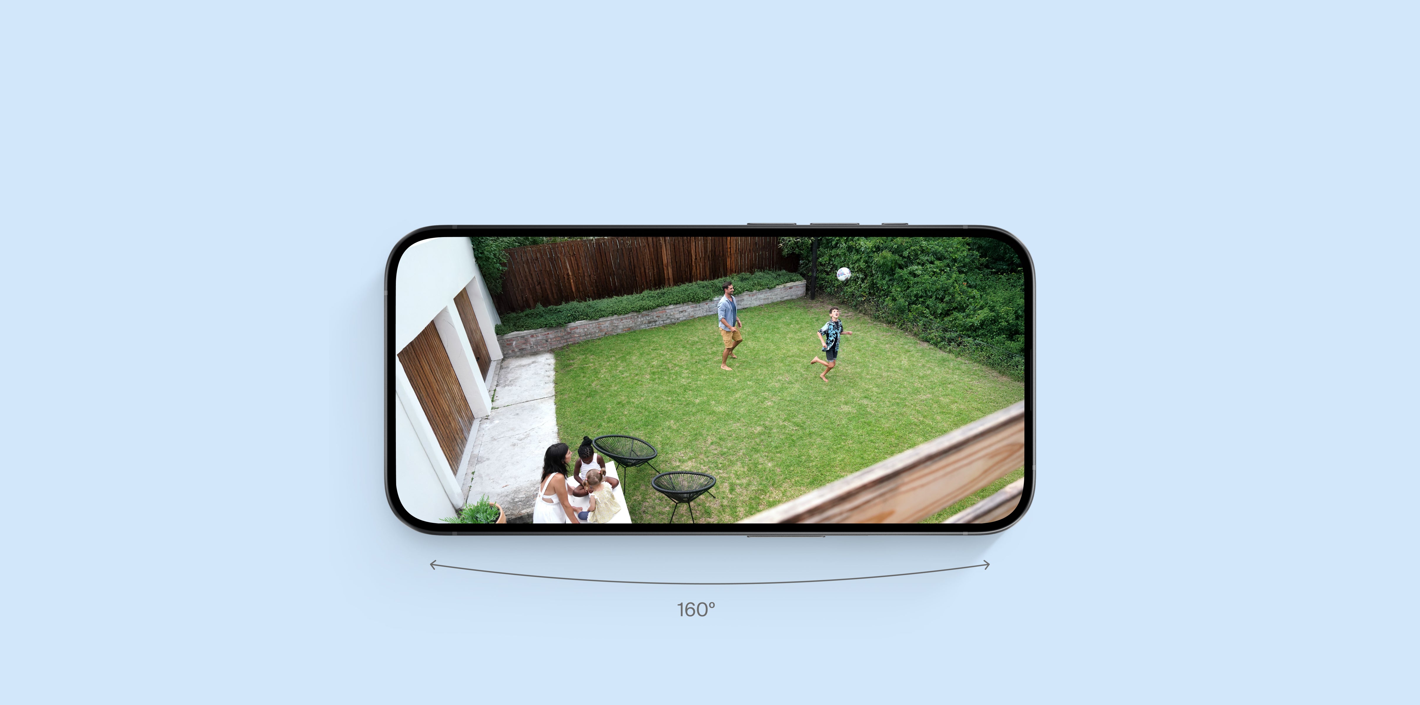Family playing in the backyard on a phone