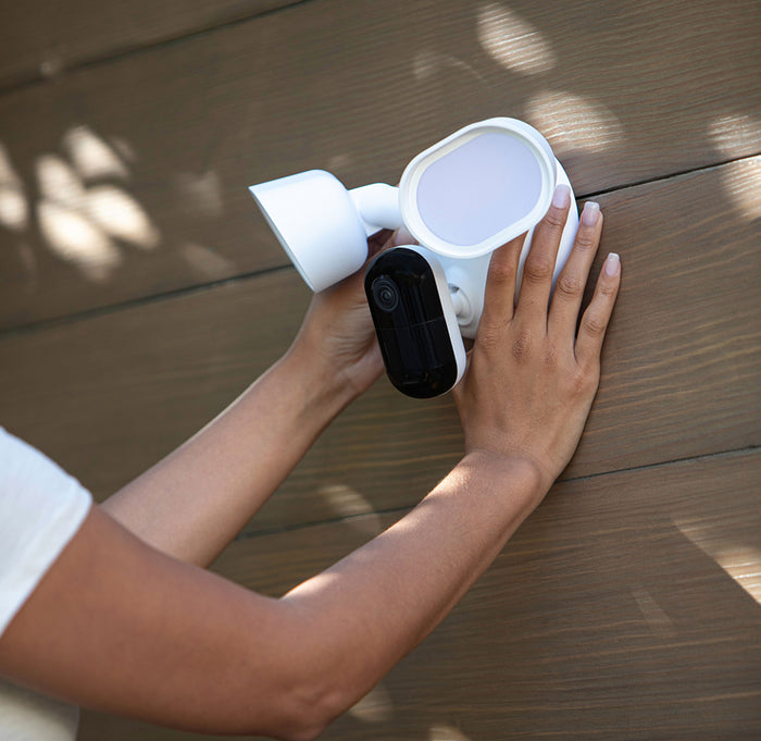 A person mounting the Arlo Wired Floodlight
