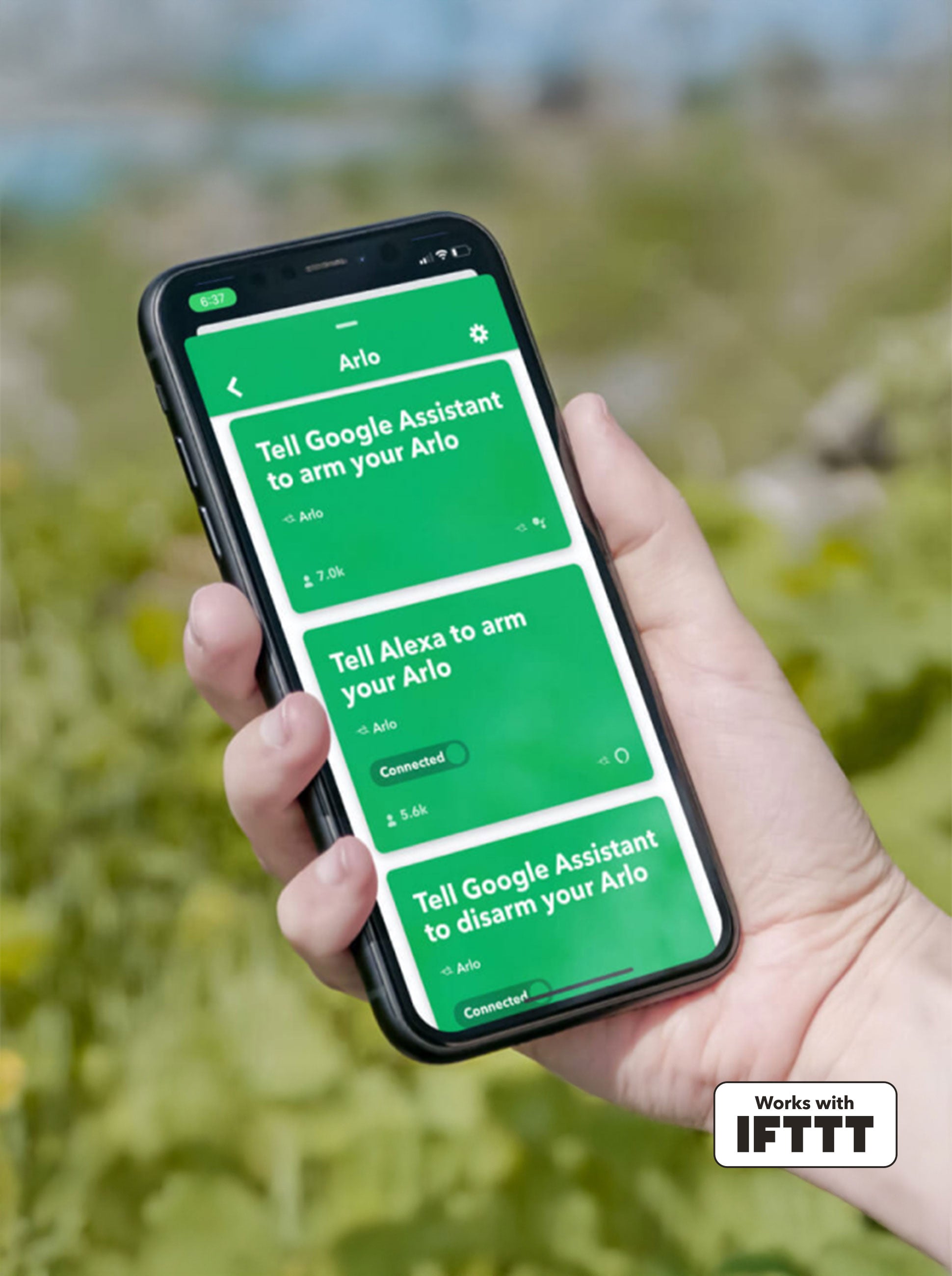 A mobile device in someone’s hand displays the compatibility of the IFTTT interface with Arlo devices and software. This allows users to create automated shortcuts and tasks such as arming or disarming your Arlo security camera across various online services and devices such as Google assist or Amazon Alexa.